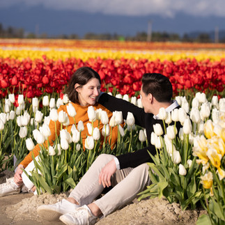 Couple smiling in white tulips at Skagit Tulip Festival