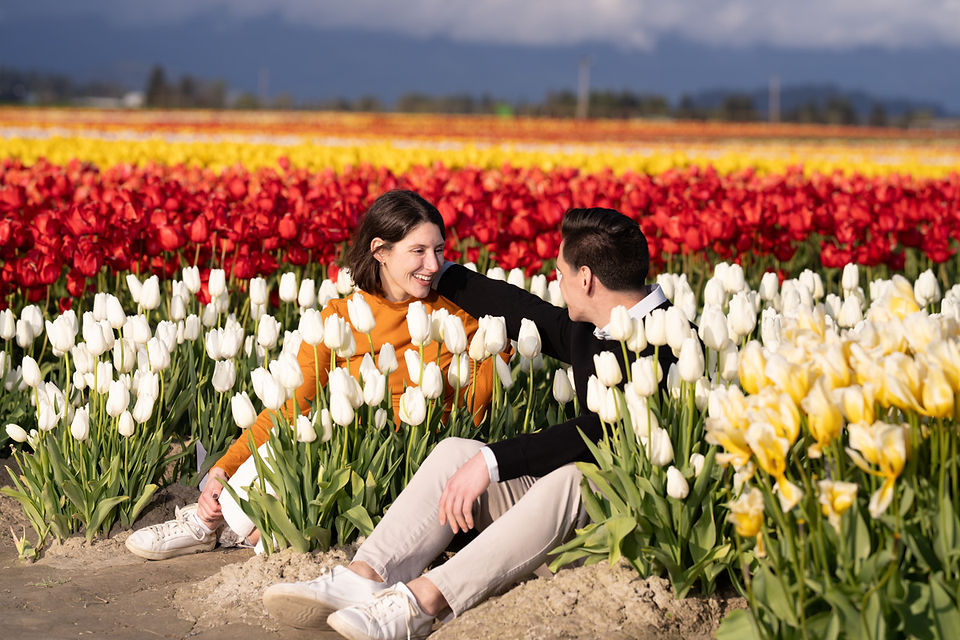 Couple smiling in white tulips at Skagit Tulip Festival