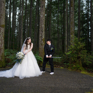 Playful wedding couple with sword at Gold Mountain Golf Club