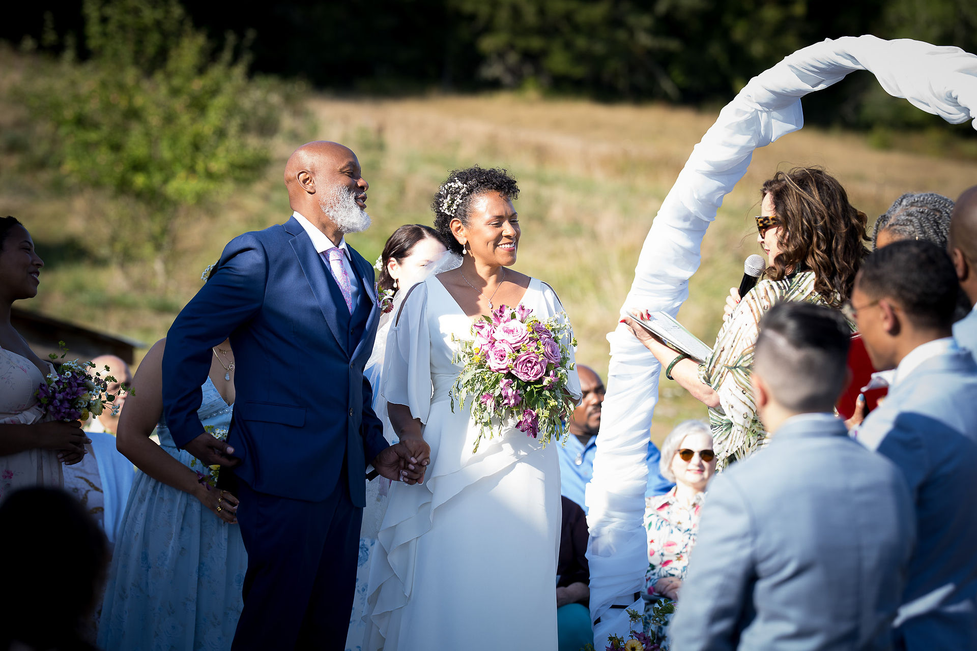 Smiling bride and groom during their outdoor wedding ceremony.