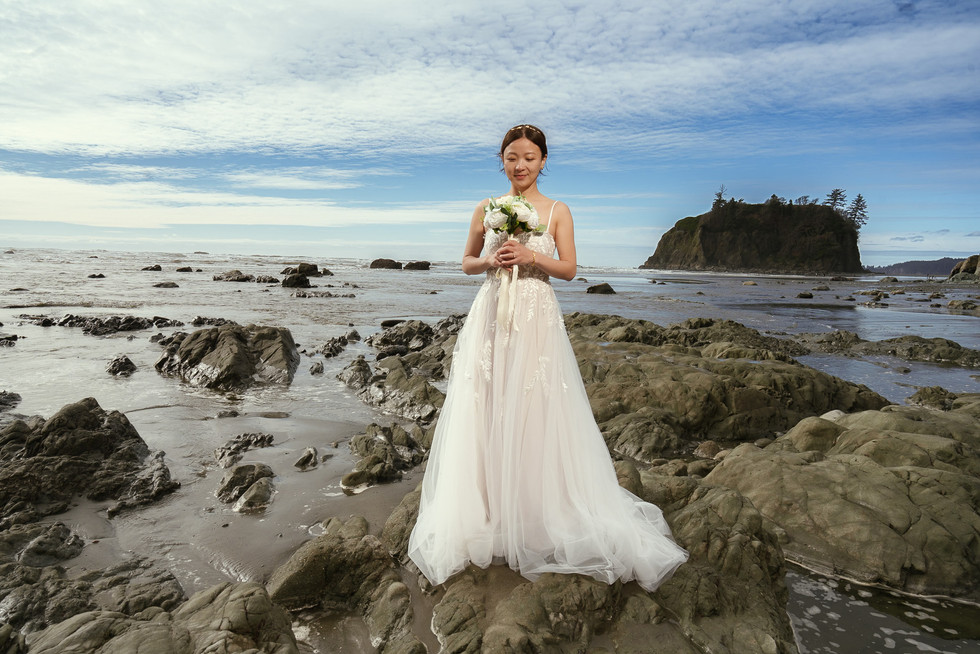 Bride on rocky beach during Olympic National Park elopement