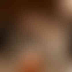 Happy older couple smiling at elegant wedding reception dinner table.