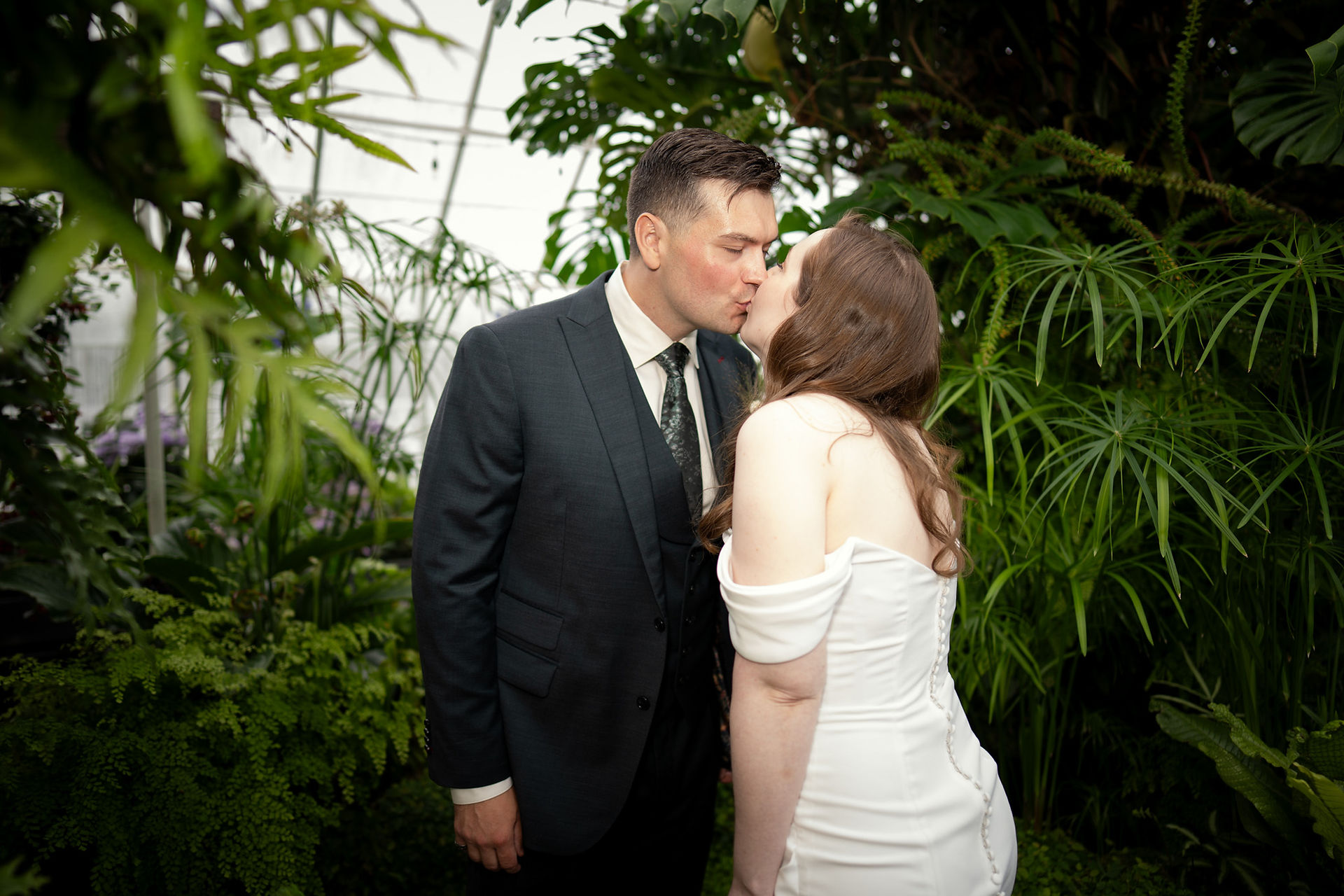 Couple kissing at Volunteer Park Conservatory in Seattle