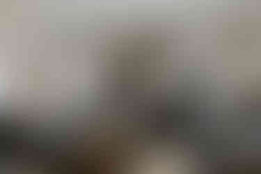 Three men in "Farmhouse" living room, one talking on phone.