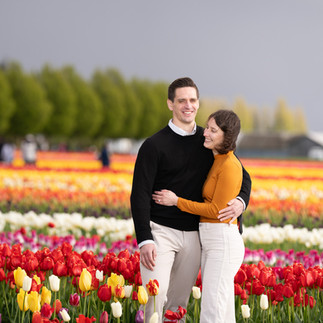 Couple smiles in a tulip field at Skagit Tulip Festival
