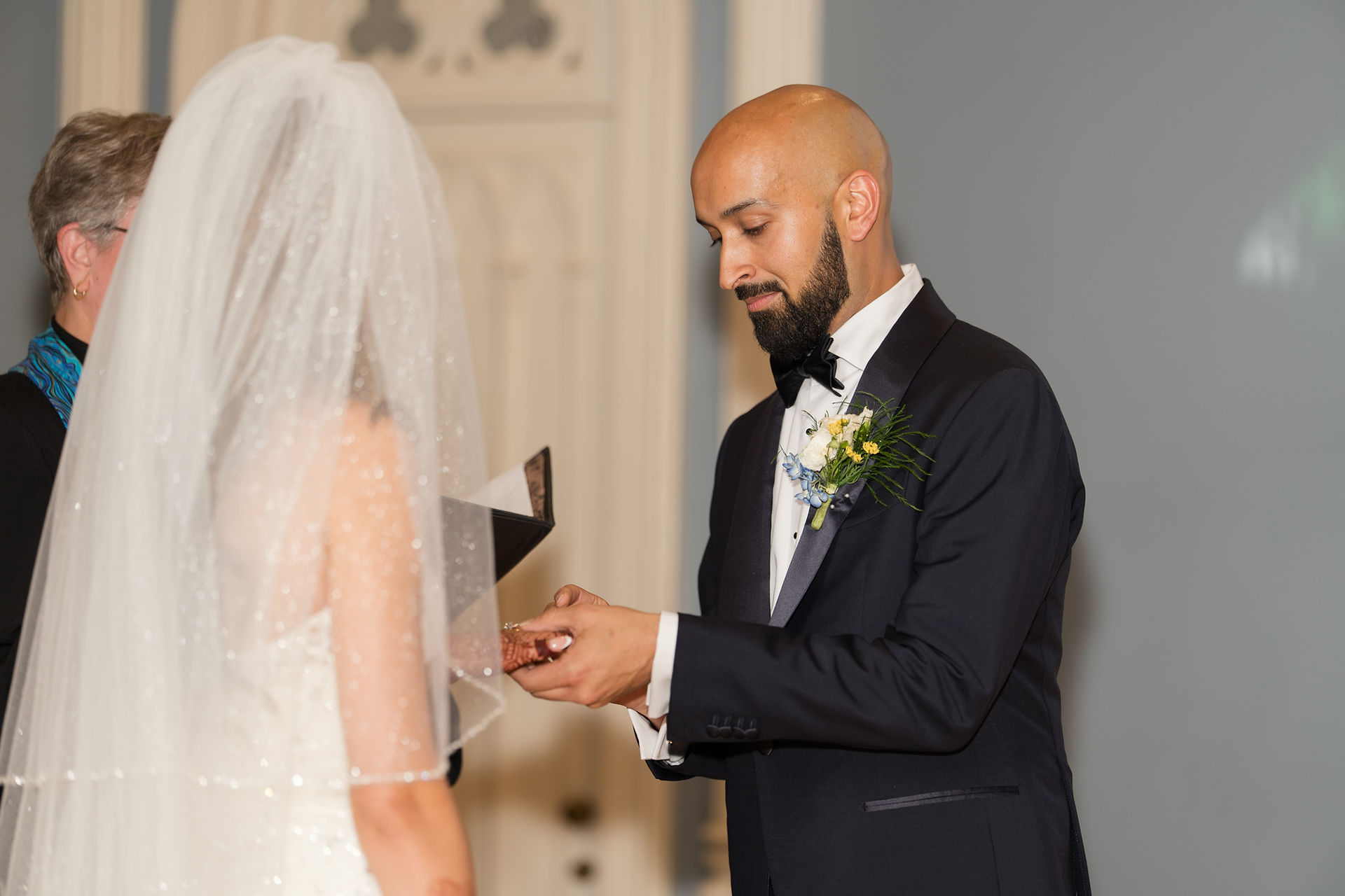 Groom placing ring on bride's finger during WA wedding ceremony