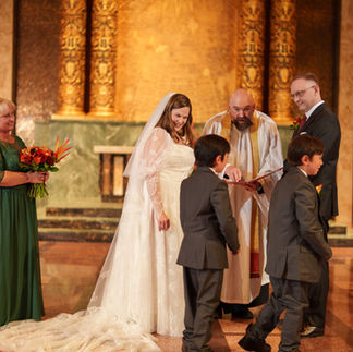 Bride, groom, officiant, children at Bastyr Chapel Wedding ceremony.