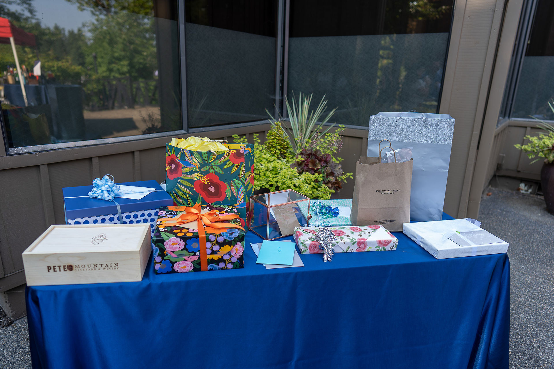 Assorted colorful gifts and bags on a bright blue table.