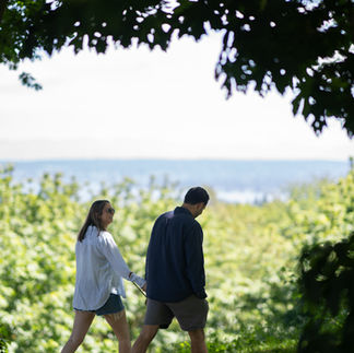 Couple holding hands, walking by Green Lake