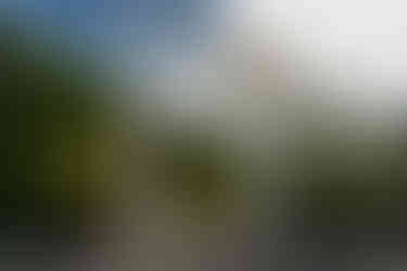 White floral wedding arch, lush garden. Weddings at Olympic View Wedding Estates.