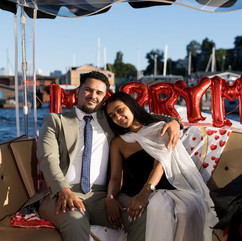 Happy couple on boat, "Marry Me" sign, Seattle Love Story: A Heartfelt Boat Proposal | She Said Yes
