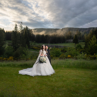 Wedding couple on grass at Gold Mountain Golf Club Weddings.