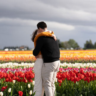 Couple embracing amidst tulips at Skagit Tulip Festival