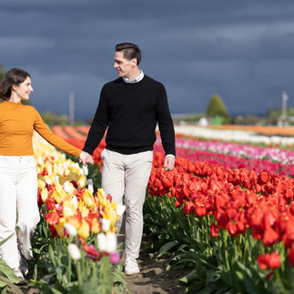 Engaged couple walking hand-in-hand at Skagit Tulip Festival