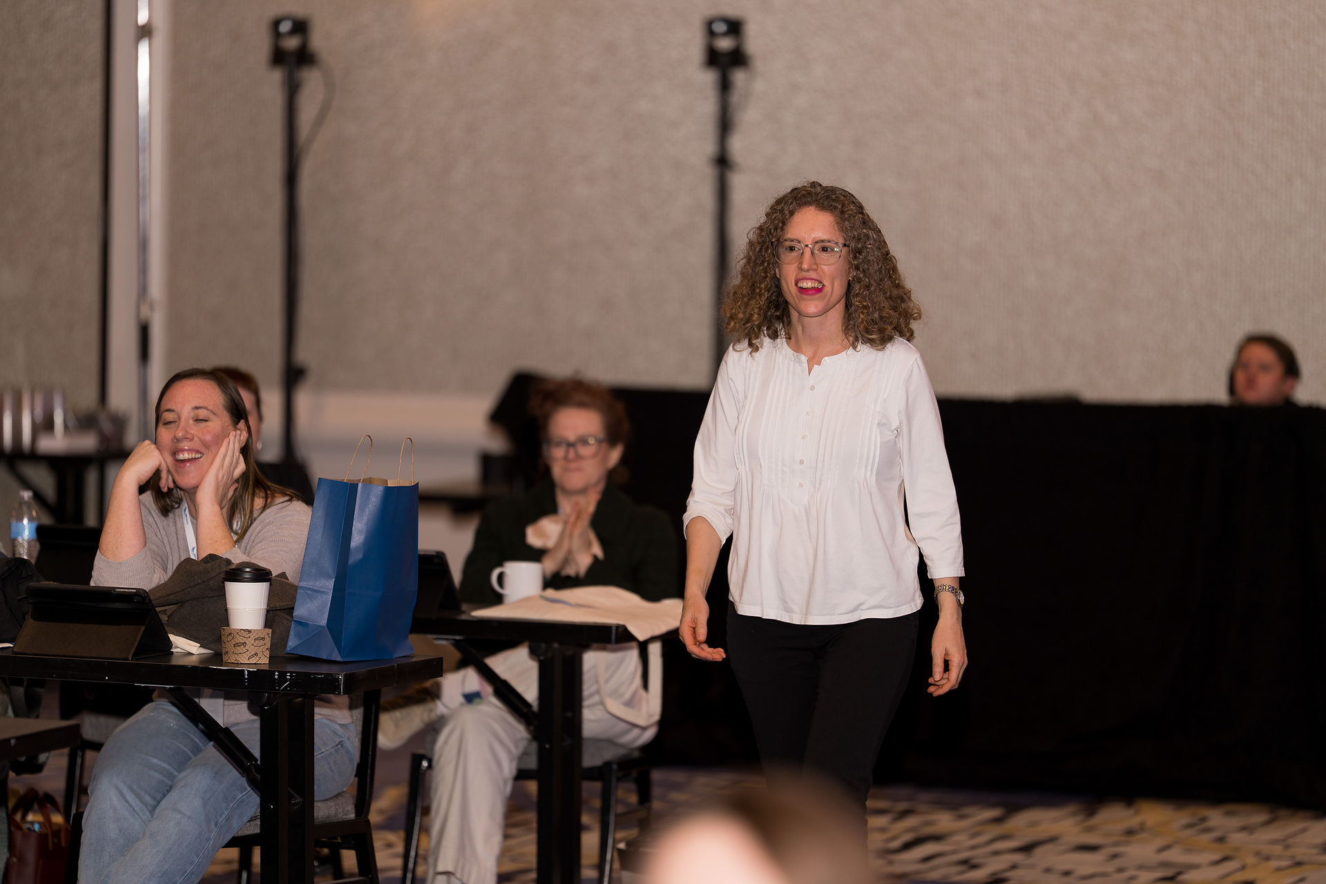 Woman with curly hair at IBD Pro Symposium. Seattle event photography.