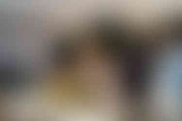 Joyful couple and guests at intimate outdoor farm wedding reception.