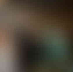 Wedding guests taking shots at a lively reception under string lights.