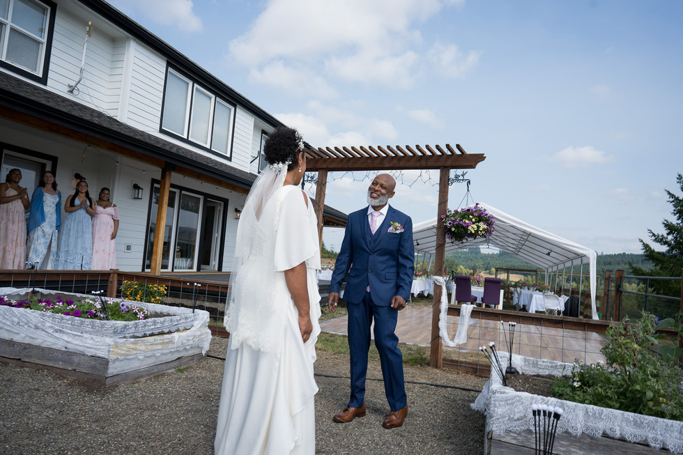 Bride and groom smiling at their intimate outdoor farm wedding.