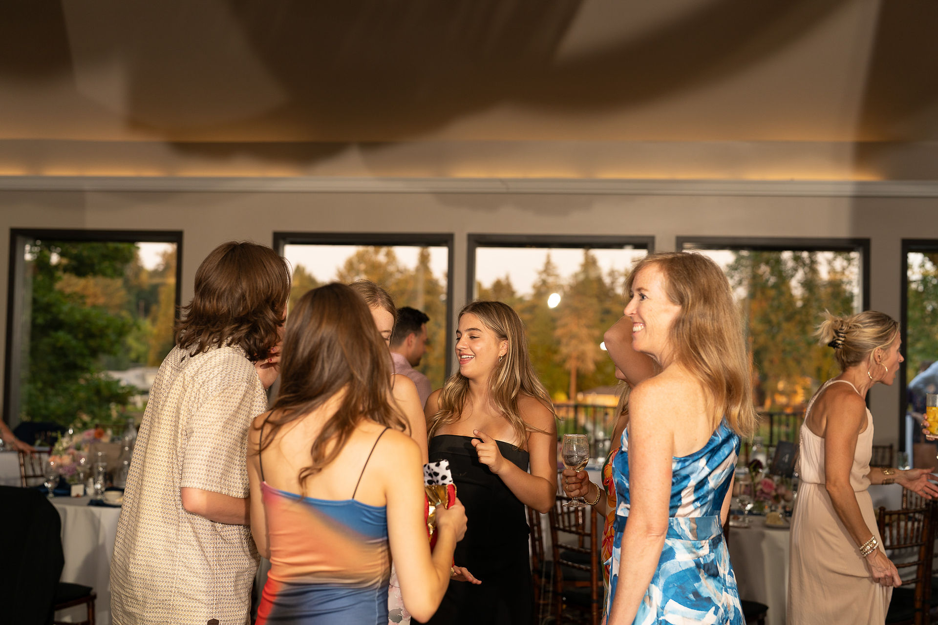 Guests smiling, conversing at The Foundry wedding in Oregon.
