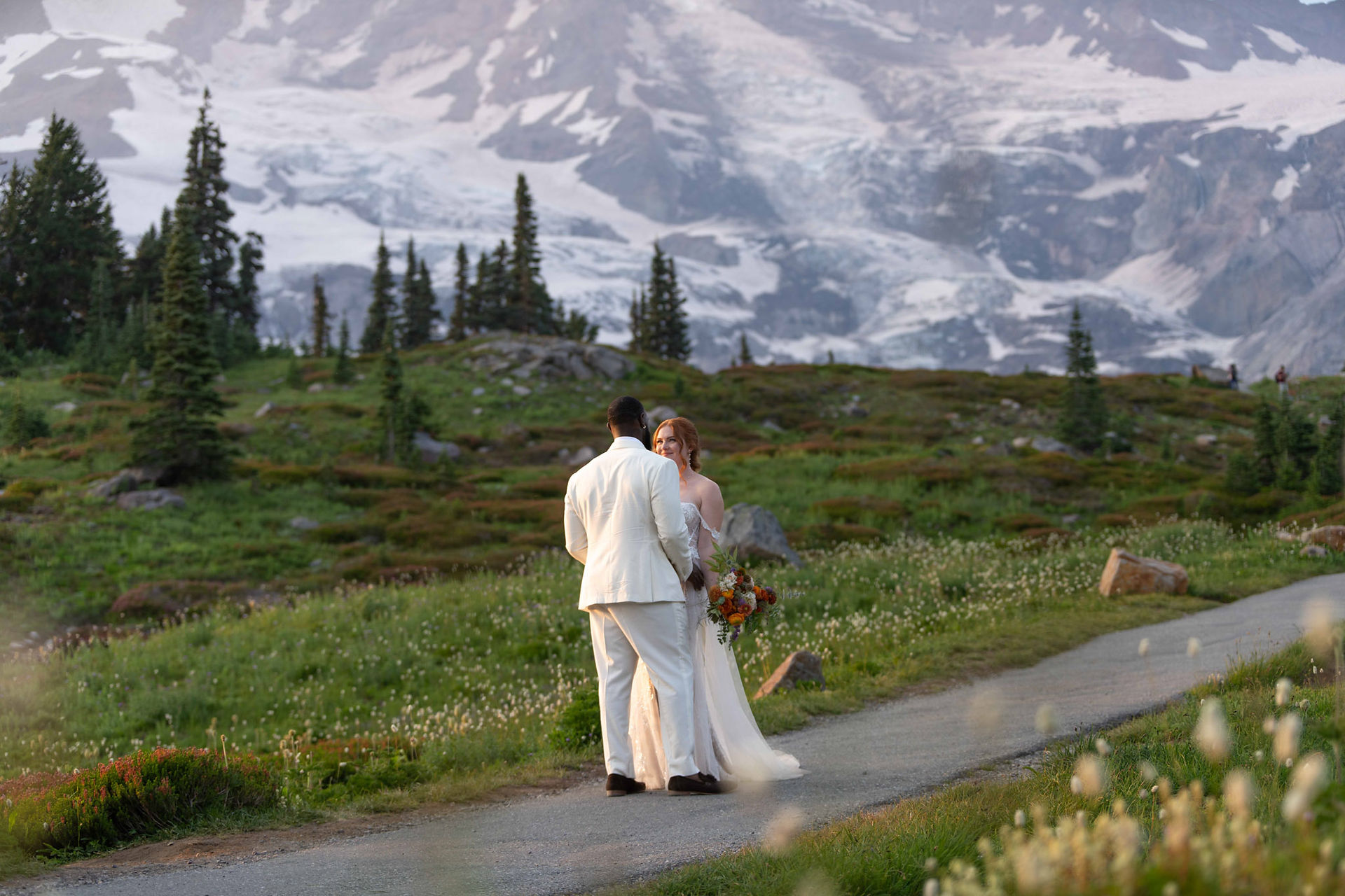 Couple embraces, mountain backdrop