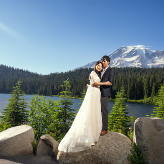 Couple at their Mount Rainier elopement by a lake.