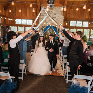 Wedding couple under sword arch at Gold Mountain Golf Club.