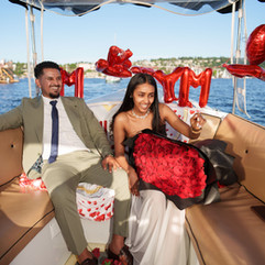 Happy couple on boat, "Marry Me" balloons, Seattle proposal