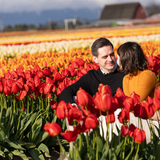Couple looking at each other in a vibrant tulip field at the Skagit Tulip Festival