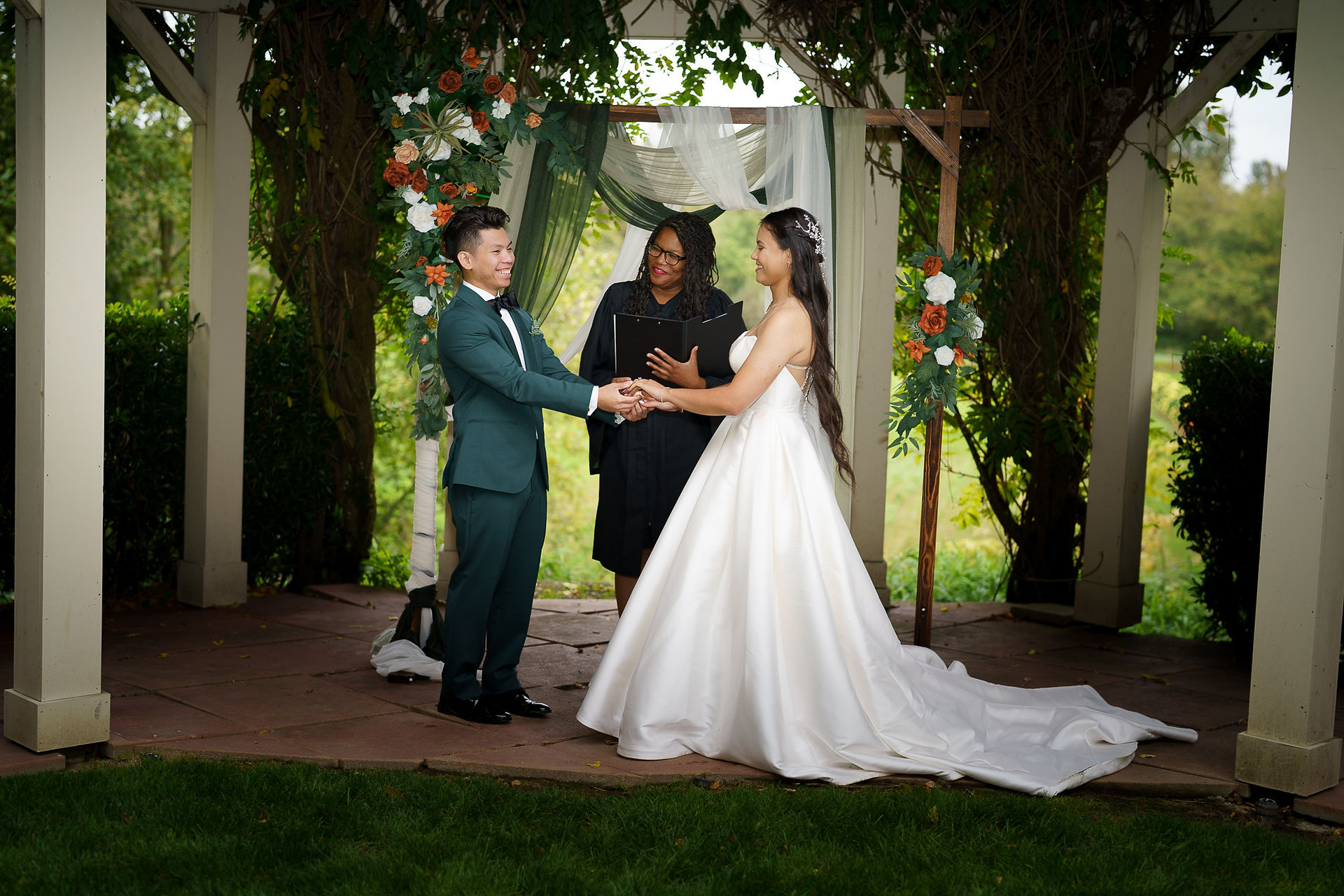Bride and groom holding hands during outdoor wedding, Sanders Estate Auburn WA.