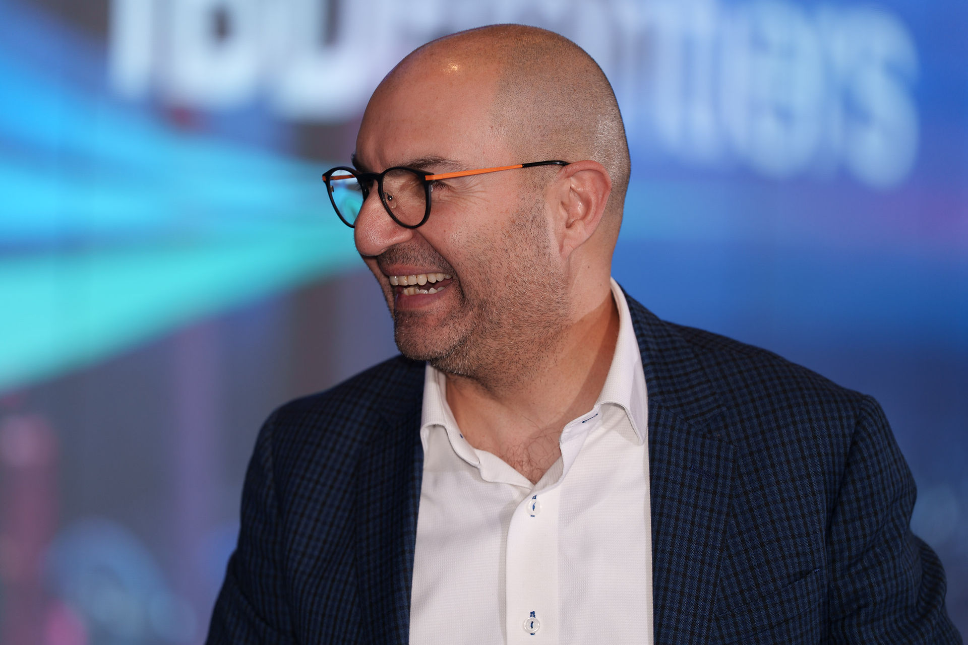 Bald man with glasses laughing