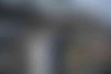 Bride and groom holding hands, exchanging vows at outdoor farm wedding.