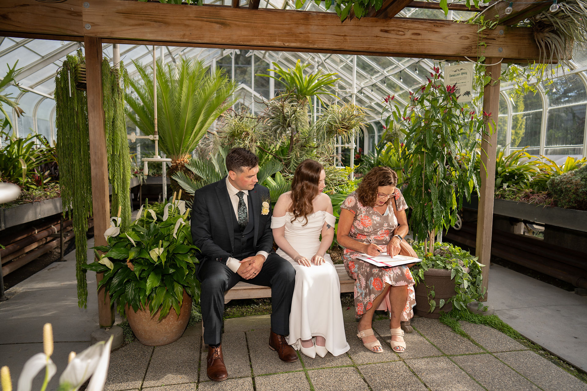 Couple signing marriage license at Volunteer Park Conservatory in Seattle