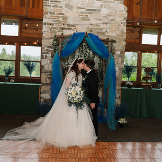 Bride and groom kissing at a Gold Mountain Golf Club wedding.