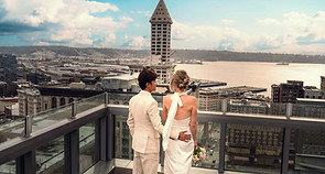 Wedding couple on Seattle rooftop with skyline view