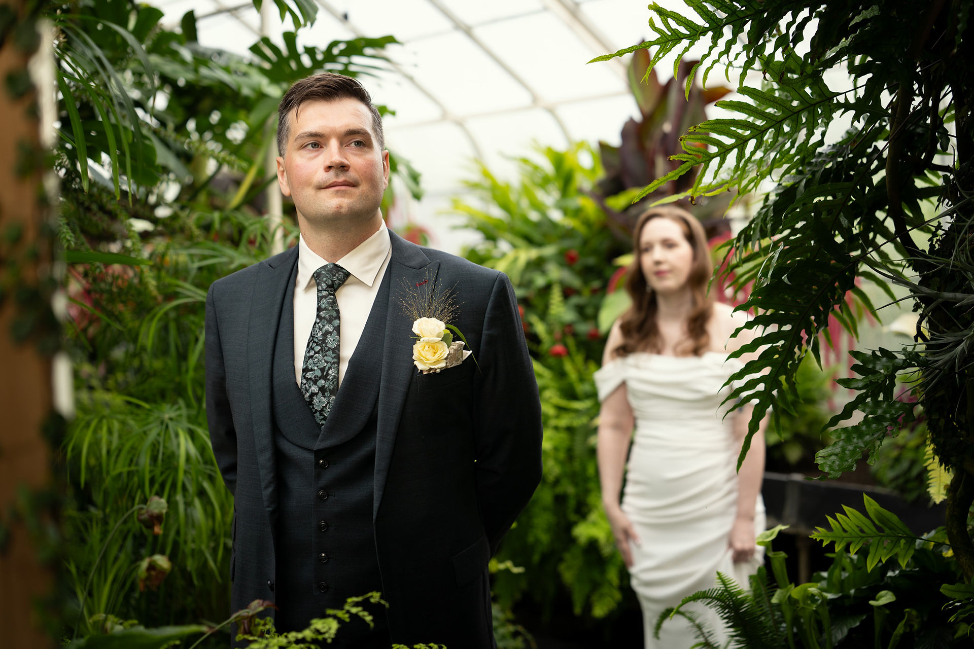 Groom waiting for bride at Volunteer Park Conservatory in Seattle