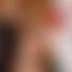 Bride and groom stand before officiant during Bastyr Chapel wedding ceremony.