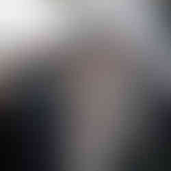 Couple exchanging vows with officiant during an intimate outdoor farm wedding.