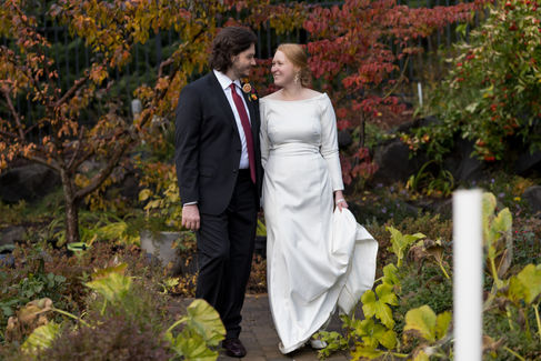 Happy couple walks in a colorful autumn garden, White Salmon WA wedding.
