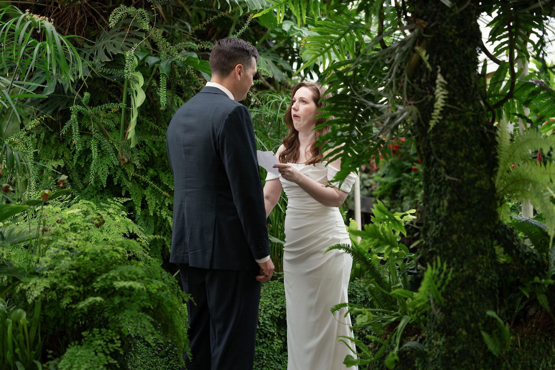 Couple exchanging vows at Volunteer Park Conservatory in Seattle