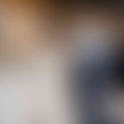 Bride and groom playfully smash wedding cake on each other's faces.