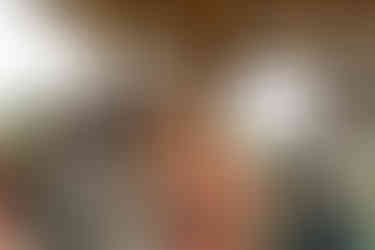 Bride and guest happily embrace at a joyful outdoor wedding celebration.