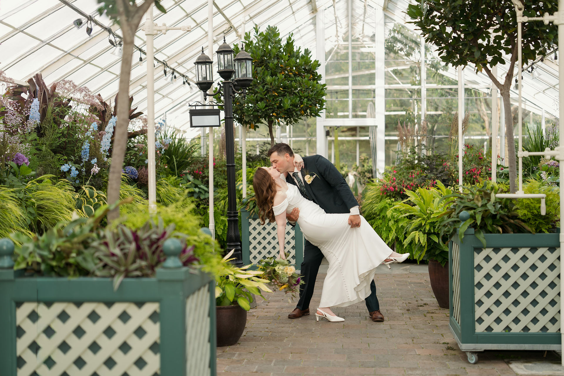 Wedding couple kissing at Volunteer Park Conservatory in Seattle