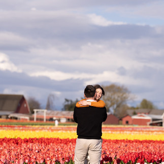 Couple hugging amidst tulips at Skagit Tulip Festival