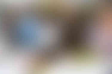 Guests serving themselves fresh fruit bowls at an outdoor buffet.
