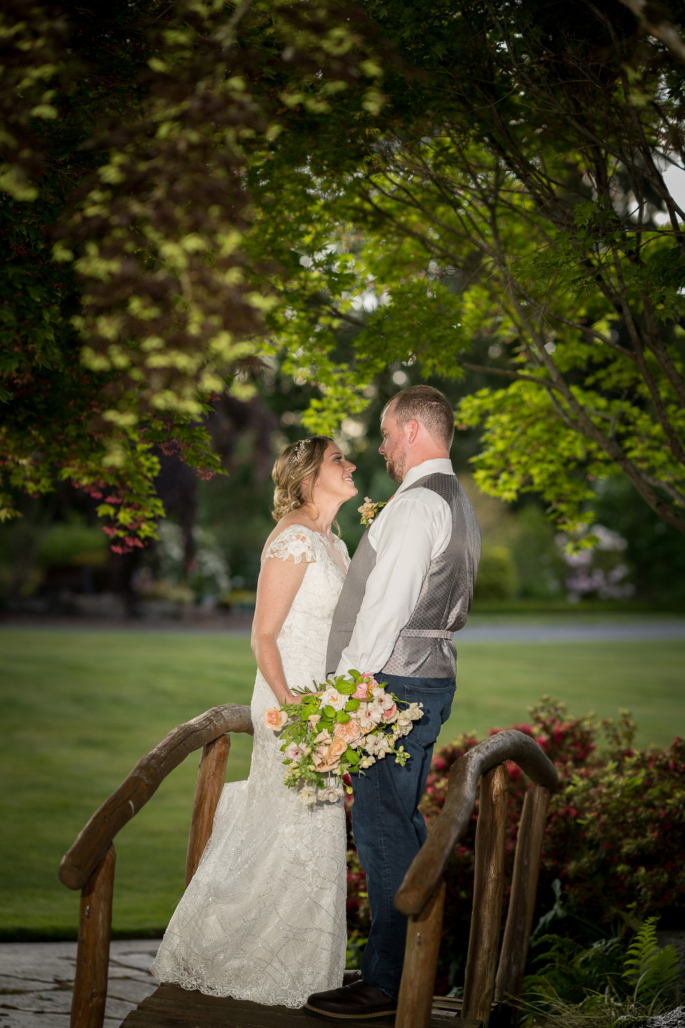 Bride and groom on bridge, outdoor wedding at Olympic View Wedding Estates.