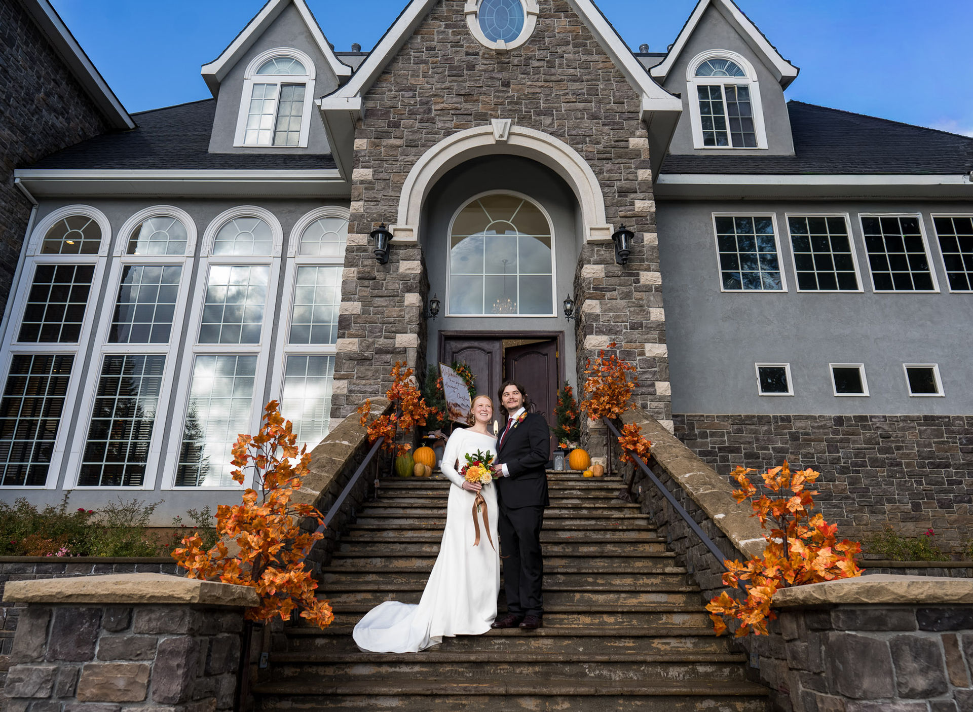 Bride and groom pose on steps of venue for wedding, portland wedding photographer