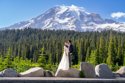 Couple on rocks for their Mount Rainier elopement