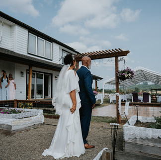 Bride and father walking to outdoor farm wedding ceremony.