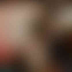 Smiling bride clapping, groom speaking with microphone at reception.