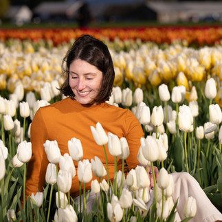 Woman smiling in a field of white tulips at the Skagit Tulip Festival